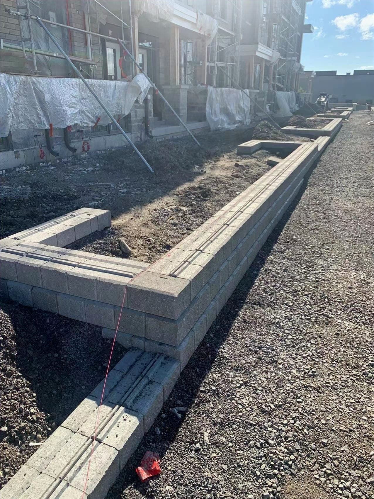 Wall block being laid to a string line