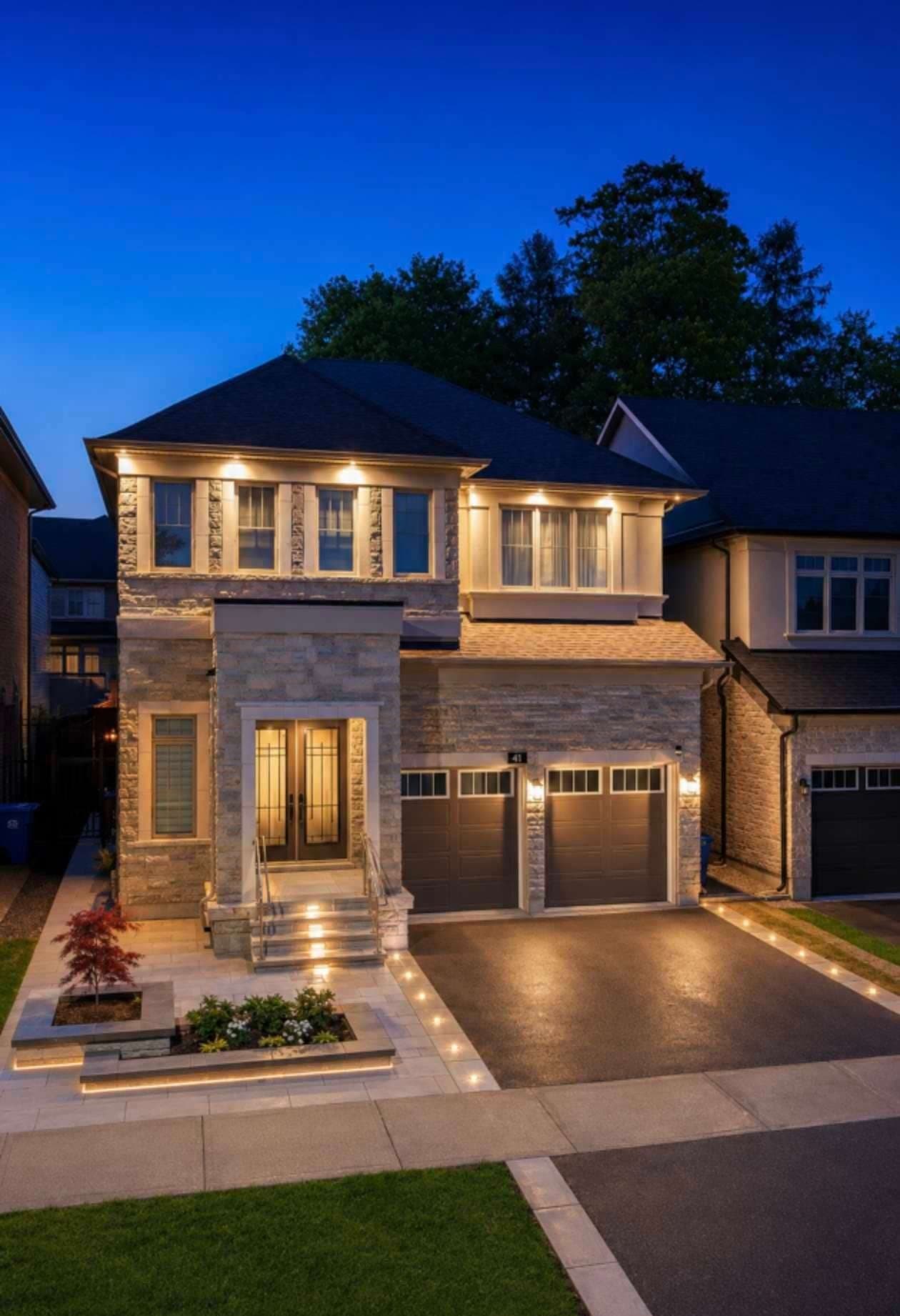 Paver driveway with inset lighting at dusk